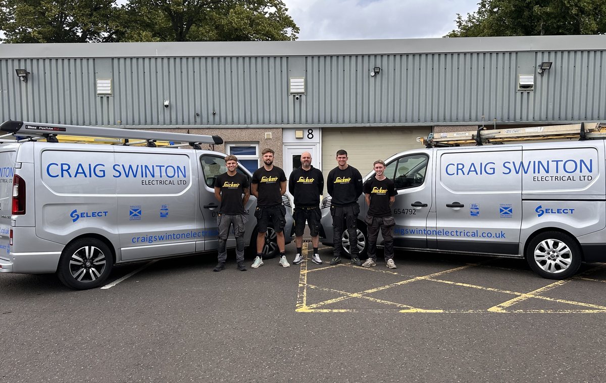 The Craig Swinton Electrical team between two branded vans outside the Cupar unit, Fife Trusted Trader member