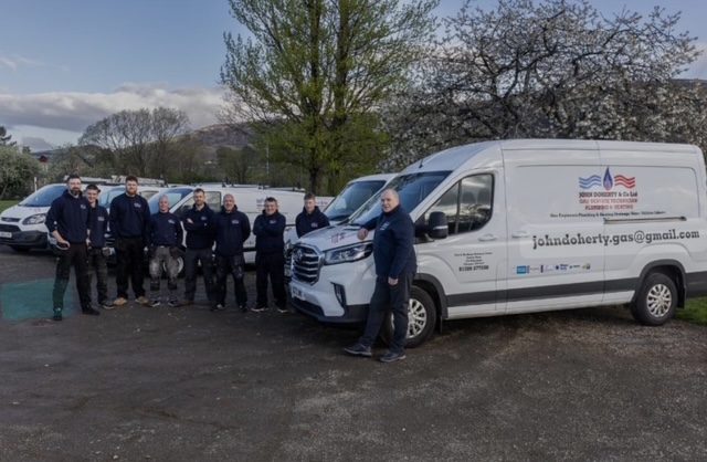 The John Doherty and Co Ltd team with part of their fleet of vans, West Dunbartonshire Trusted Trader member