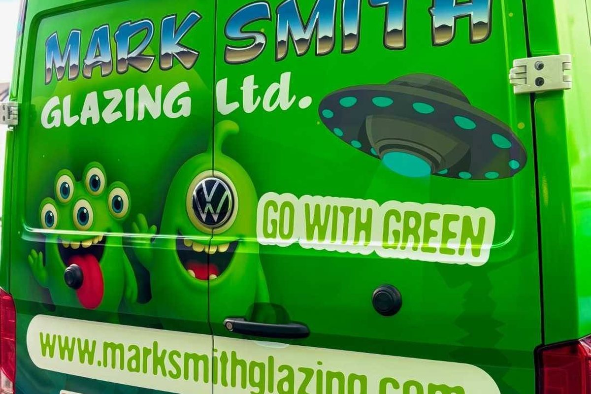 A bright green Mark Smith Glazing van carrying the company name and accreditation logos, Edinburgh Trusted Trader member